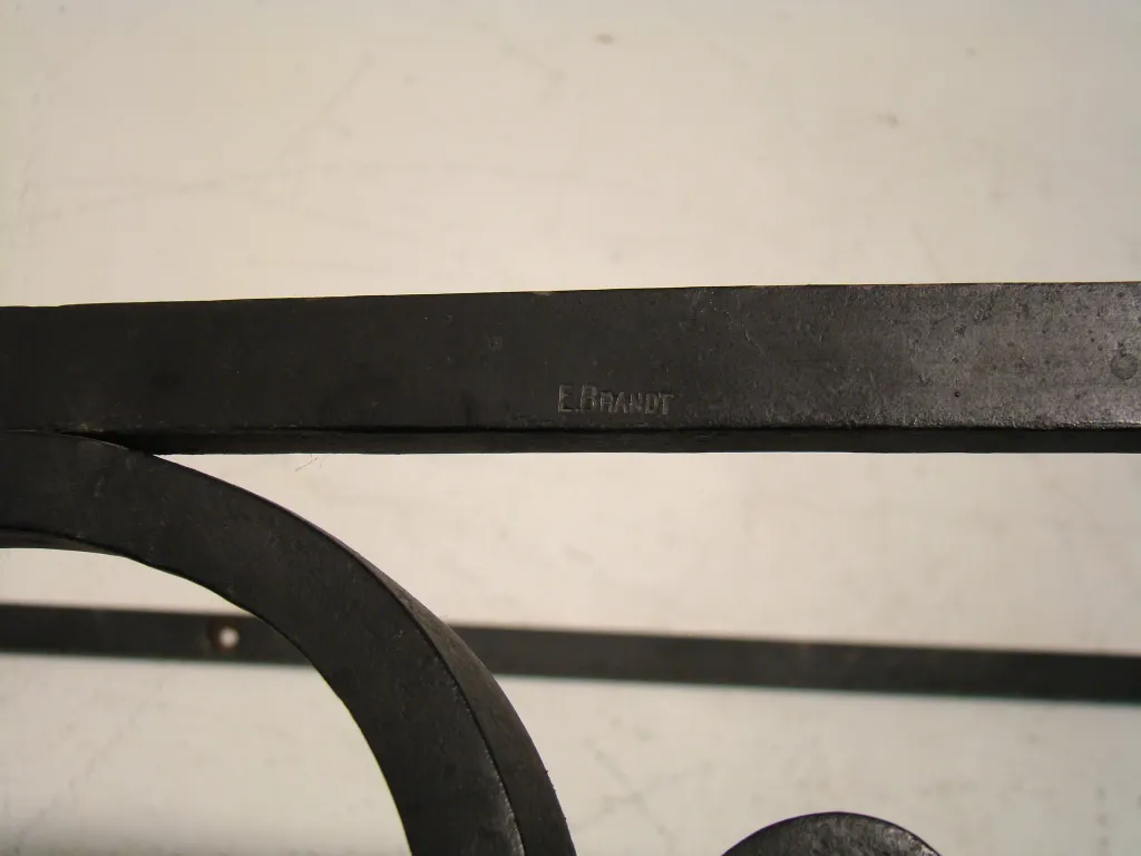 Vintage decorative console by Edgard Brant in dark color, featuring elegant design and ornamental details.