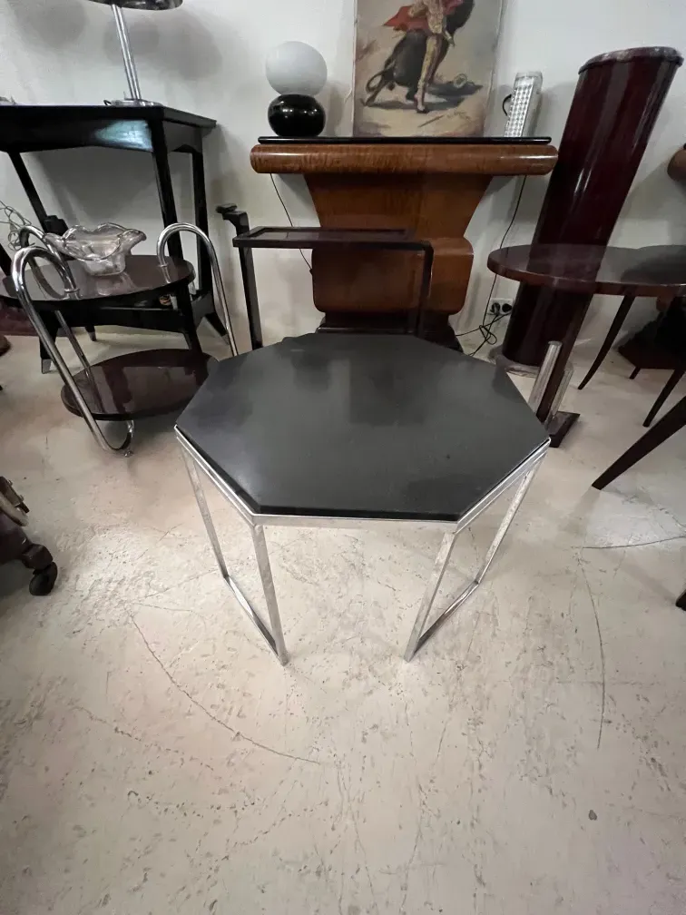 Antique coffee table with hexagonal design in a vintage setting.