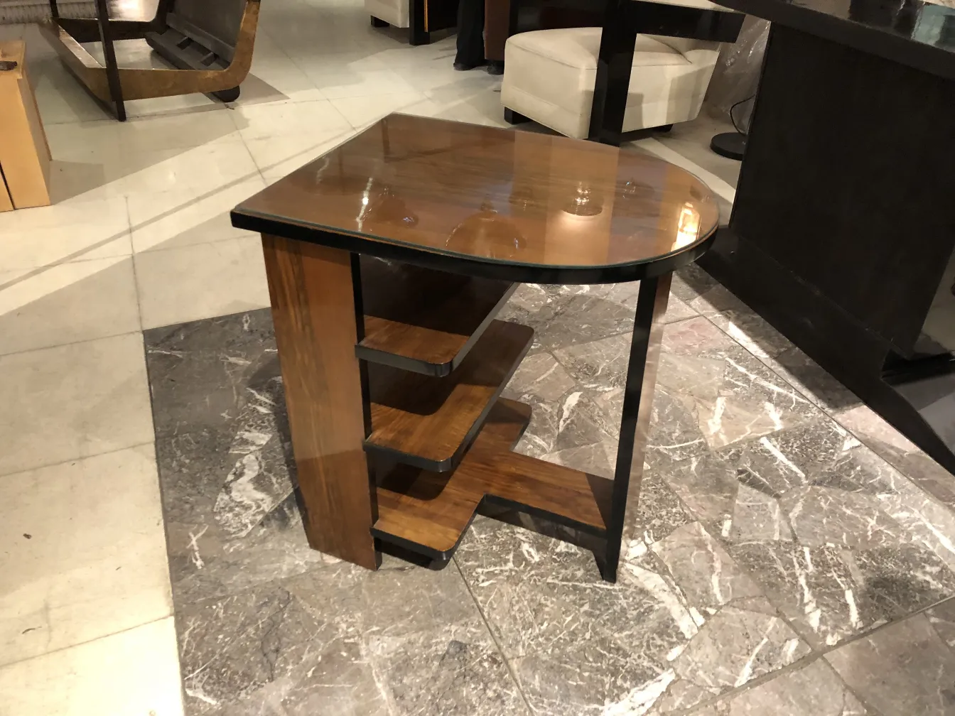 Antique Art Deco table with shelves. Elegant setting.