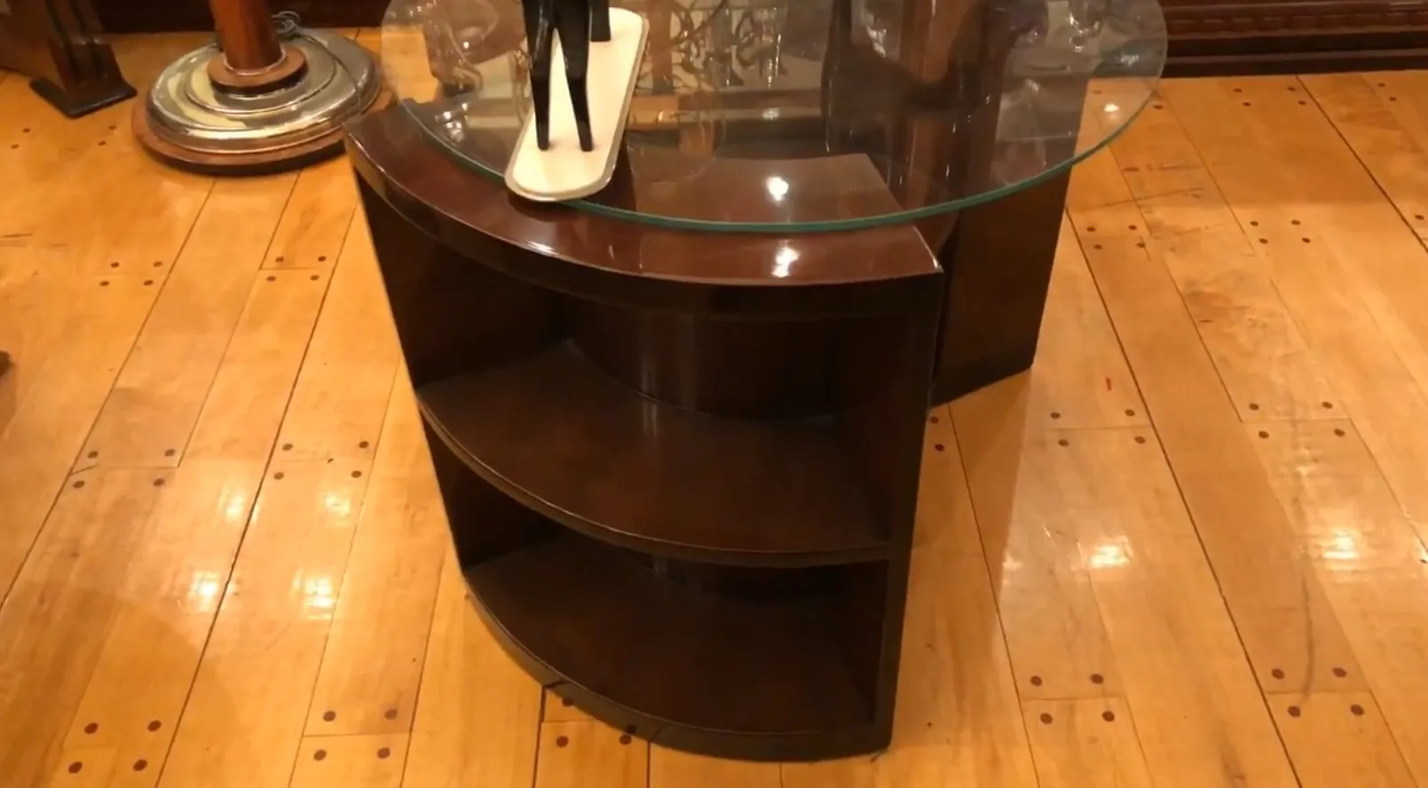 Antique Art Deco table with rounded shelves in an elegant setting.