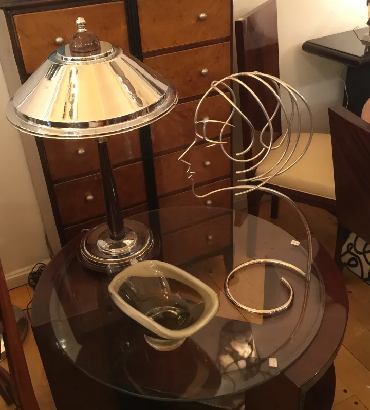 Antique table featuring a silver lamp and modern decor