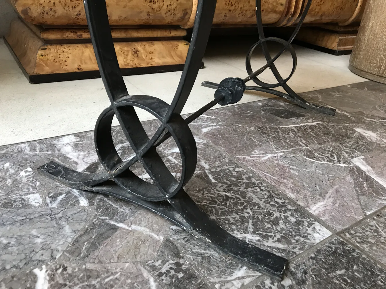 Antique table base with art deco design, modern setting.