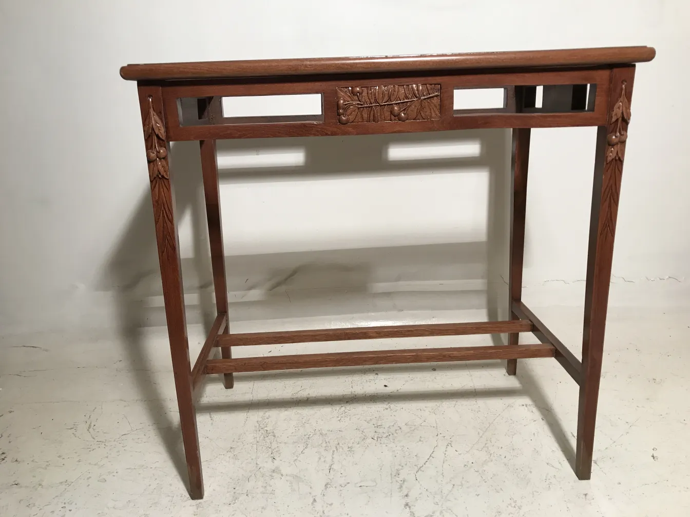 antique table with decorative carvings on the front