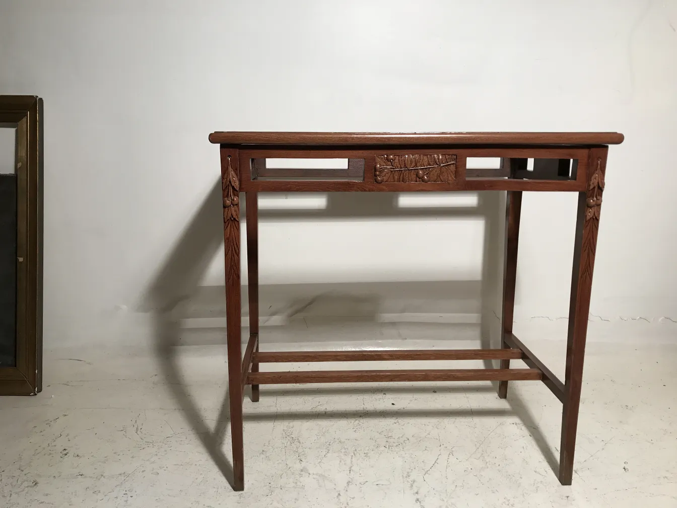 Antique table in Art Nouveau style with decorative features and neutral background