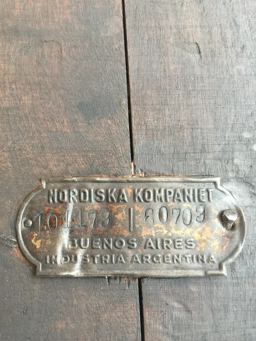 nordiska kompaniet brand plate on an antique table