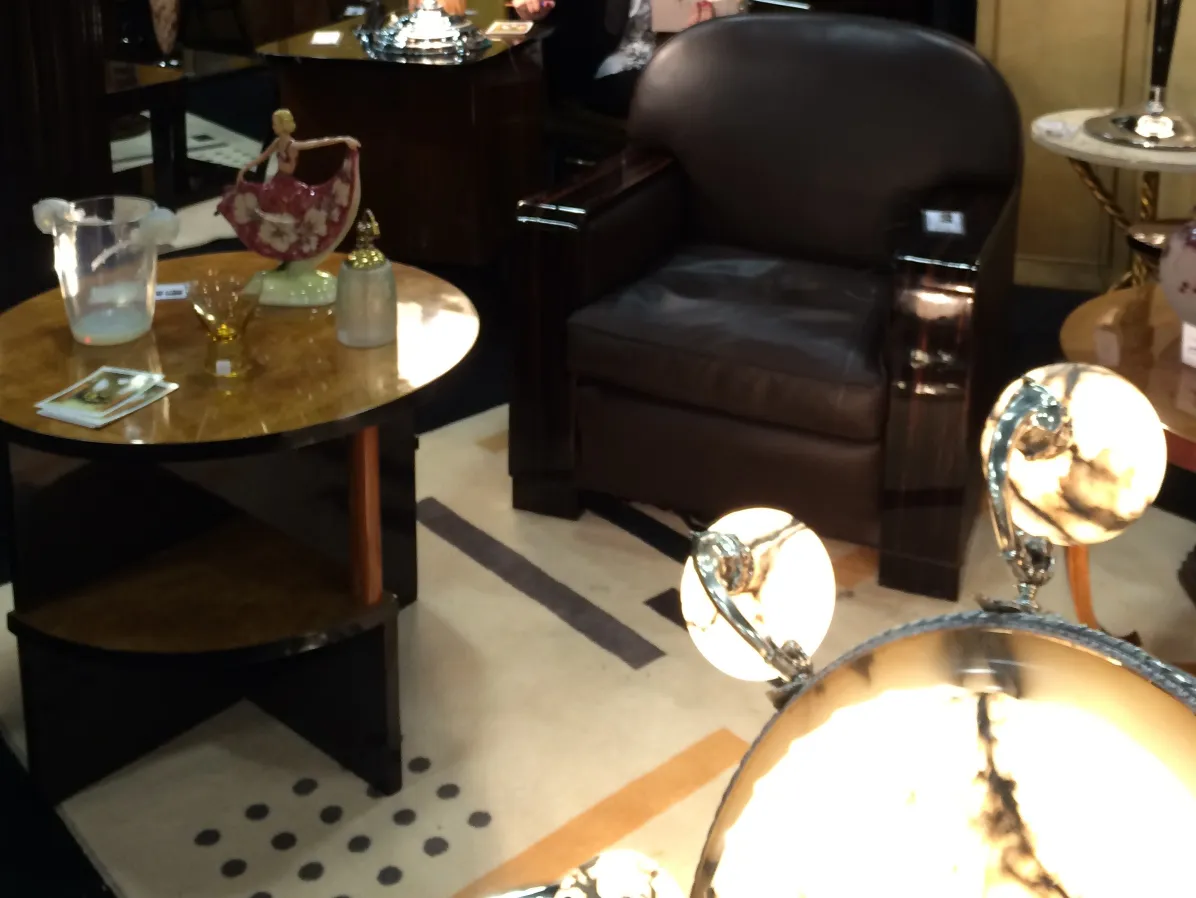 Two antique small tables in an elegant setting with Art Deco decor.