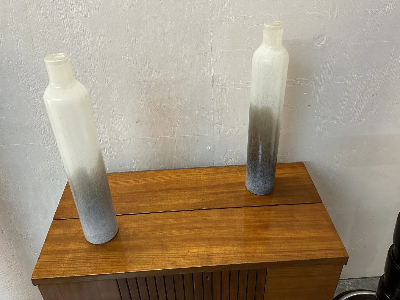 two antique murano vases on a wooden surface