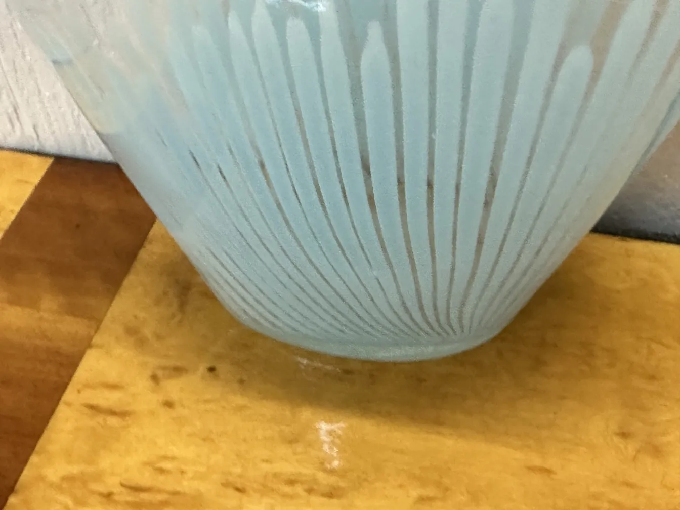 Two antique Murano vases in light blue with elegant, decorative details on a table