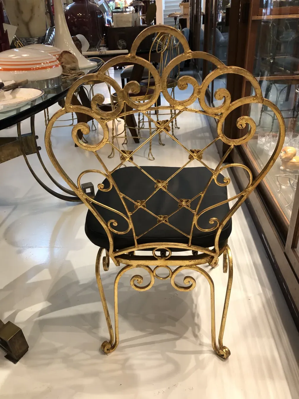 Vintage garden chairs with intricate designs in a bright setting