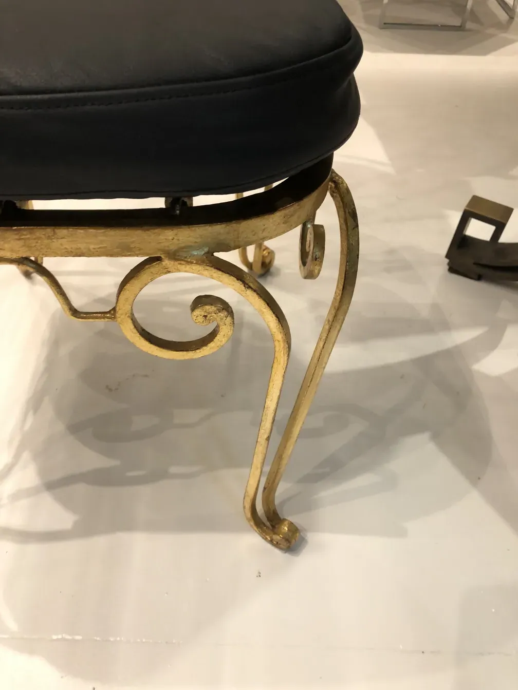 Side view of 2 antique garden chairs with decorative details