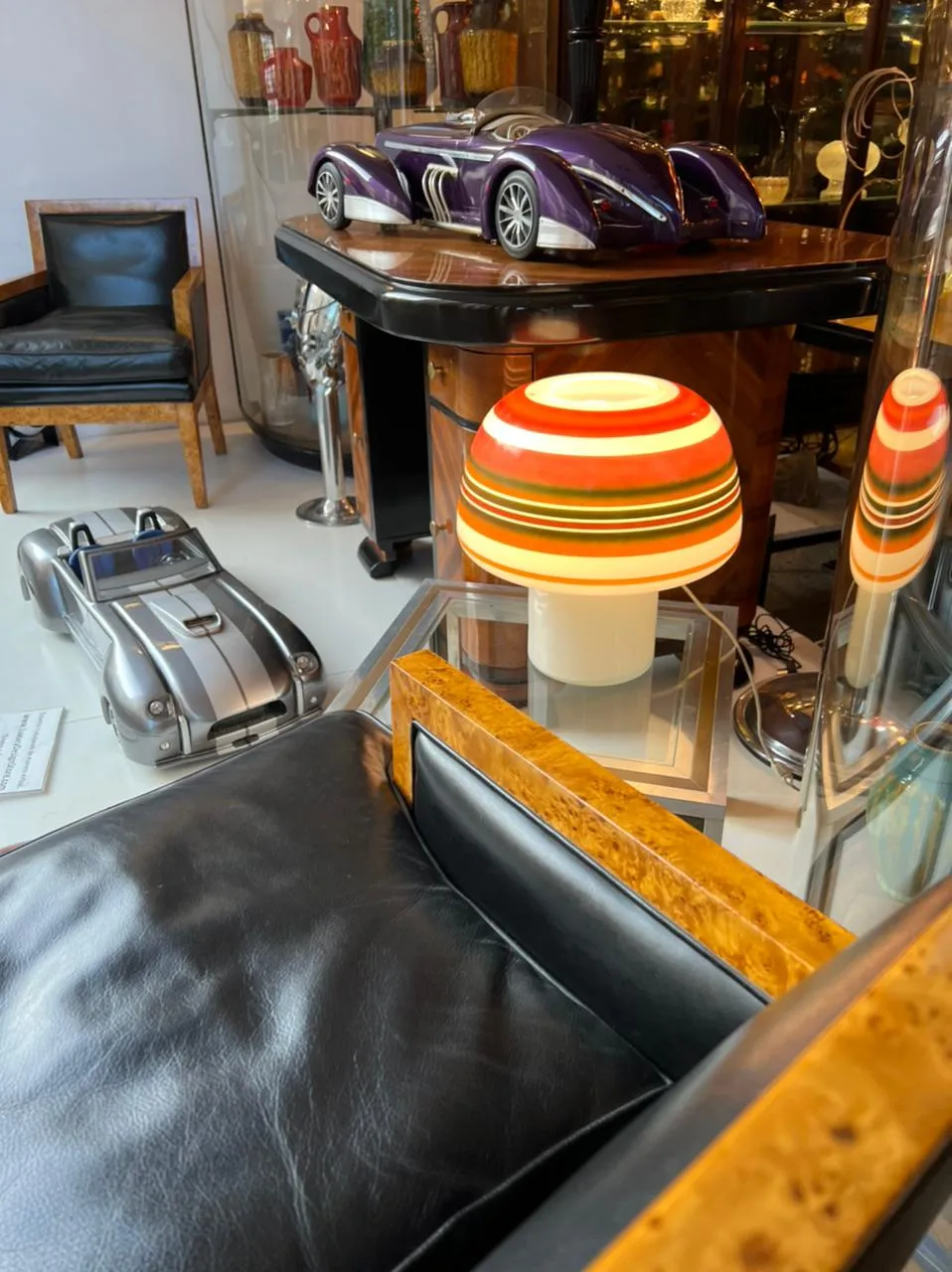 view of two antique armchairs with low back in an elegant setting