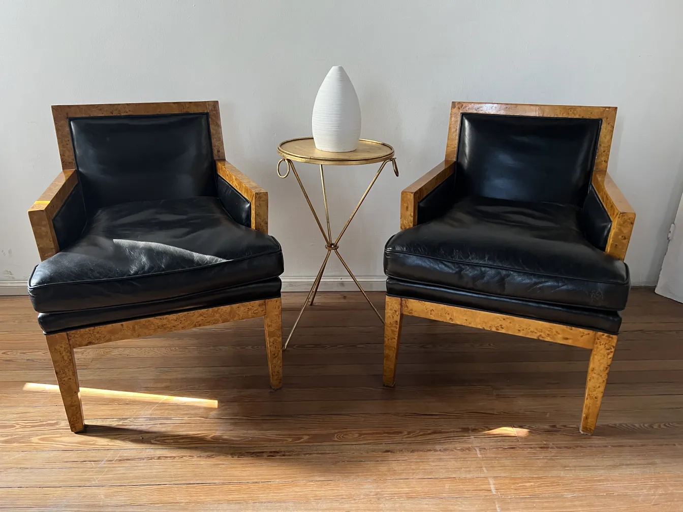 Two antique armchairs with light wood and black leather