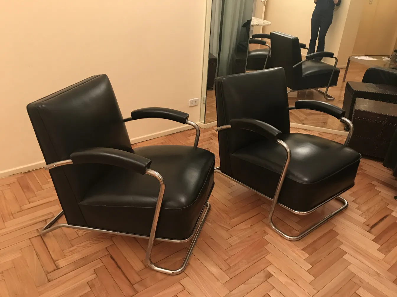 Two black armchairs with elegant design in a cozy setting.