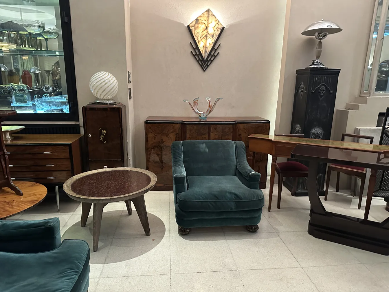 two antique armchairs in an elegant setting, one armchair is green