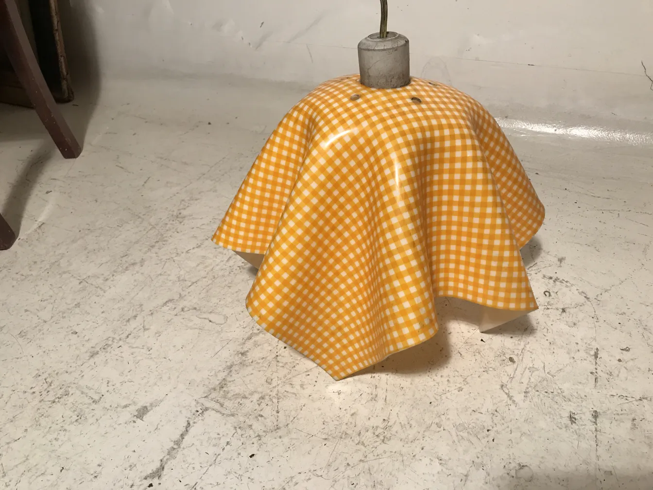 antique hanging lamp in yellow with a checkered design that stands out in the scene