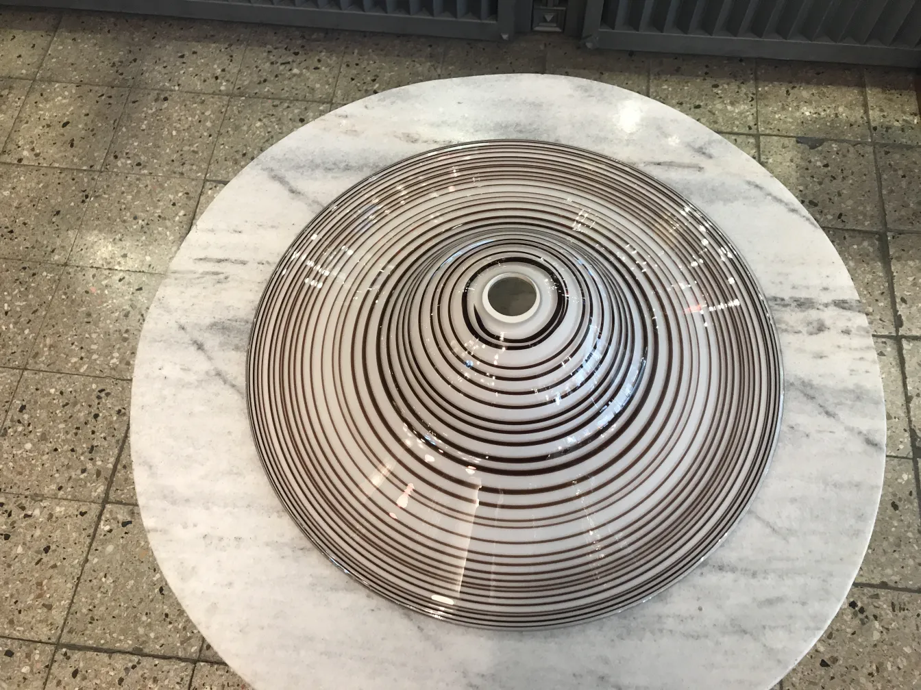 antique hanging lamp with circular designs on a white table