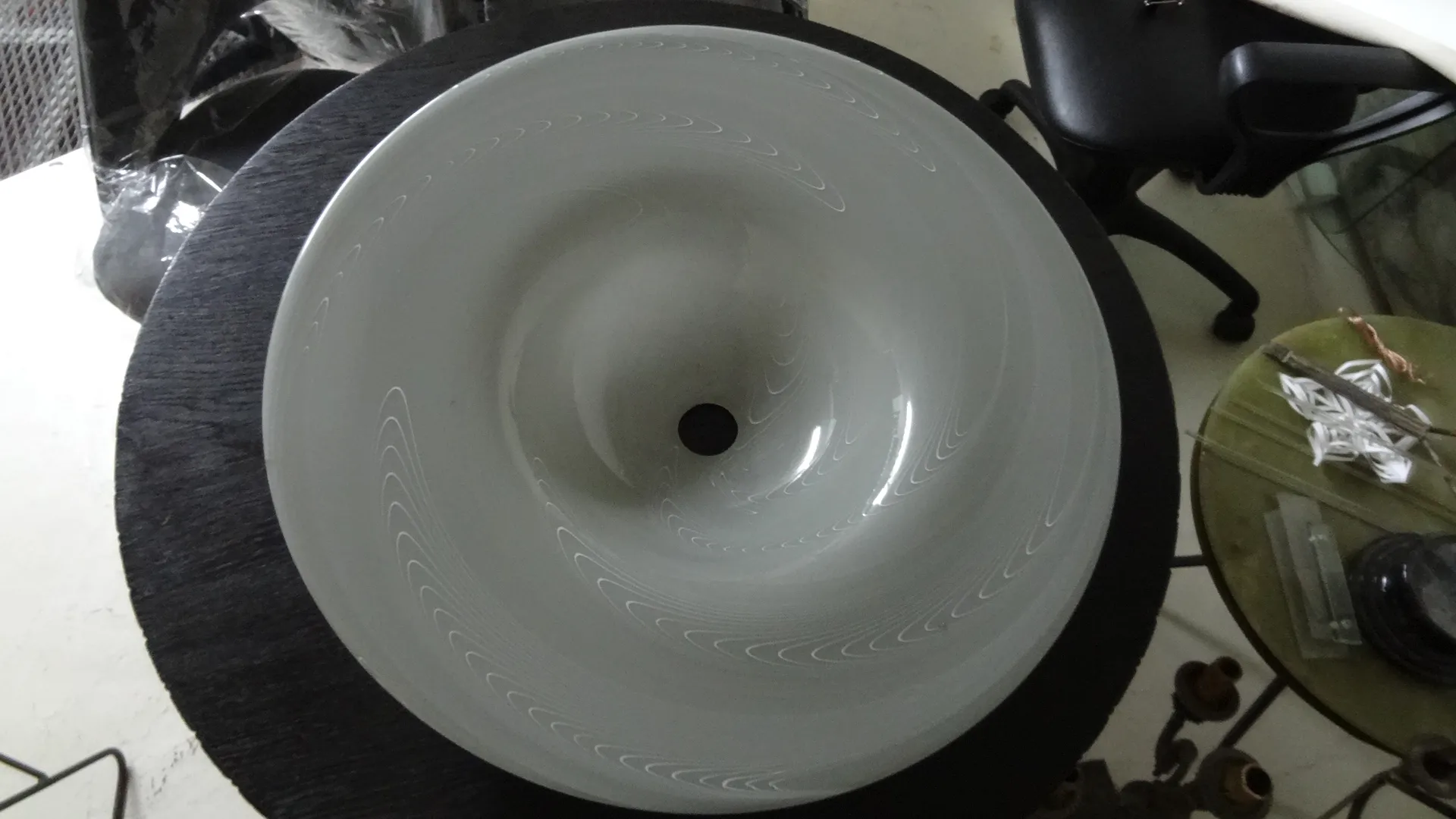 antique hanging lamp with white wavy design, black background