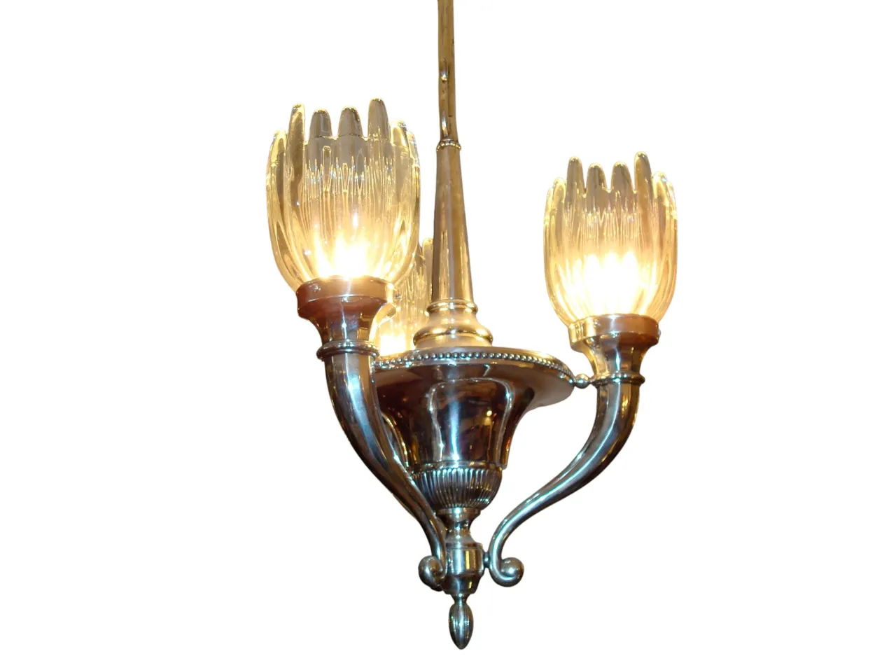 Antique hanging lamp with bright lights and elegant design in retro setting.