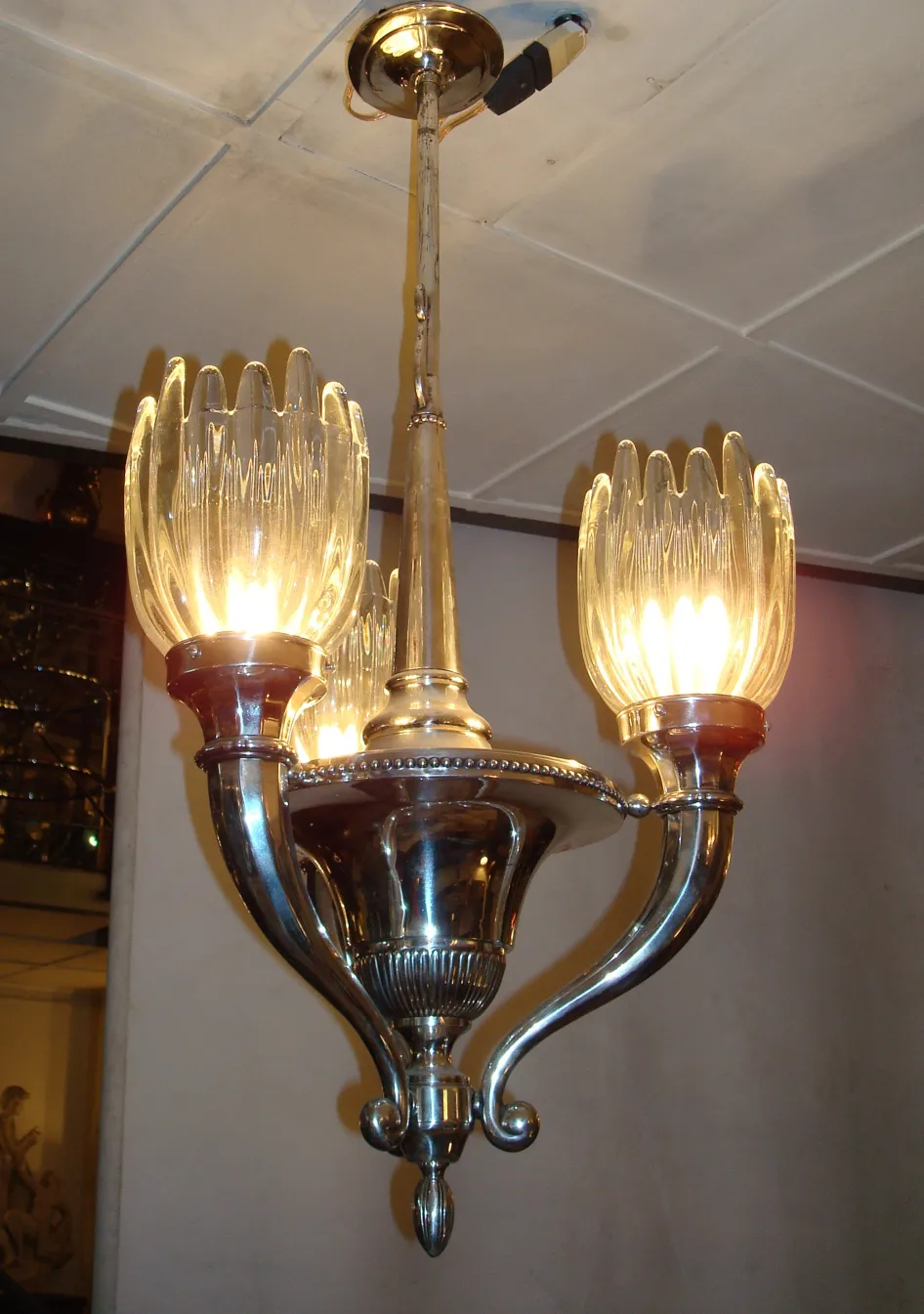 antique hanging lamp with four bright lights in a well-lit environment