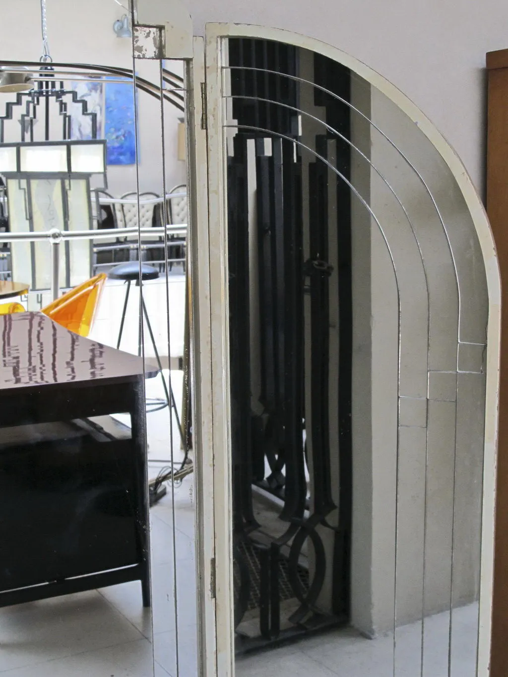 antique mirror with art deco design, well-lit area