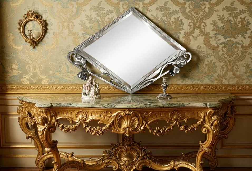 antique mirror with decorative gold design and art nouveau style, against an ornate wall