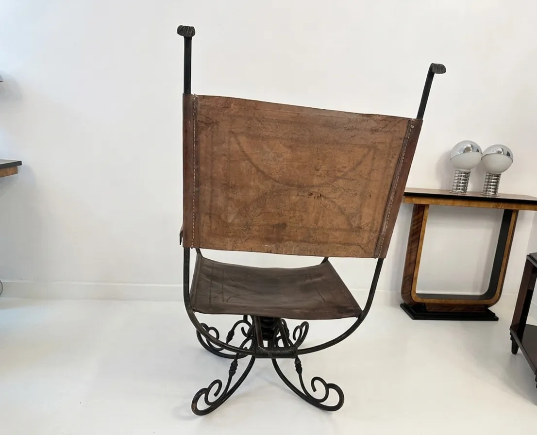 Antique armchair with Art Deco design, brown color in modern setting.