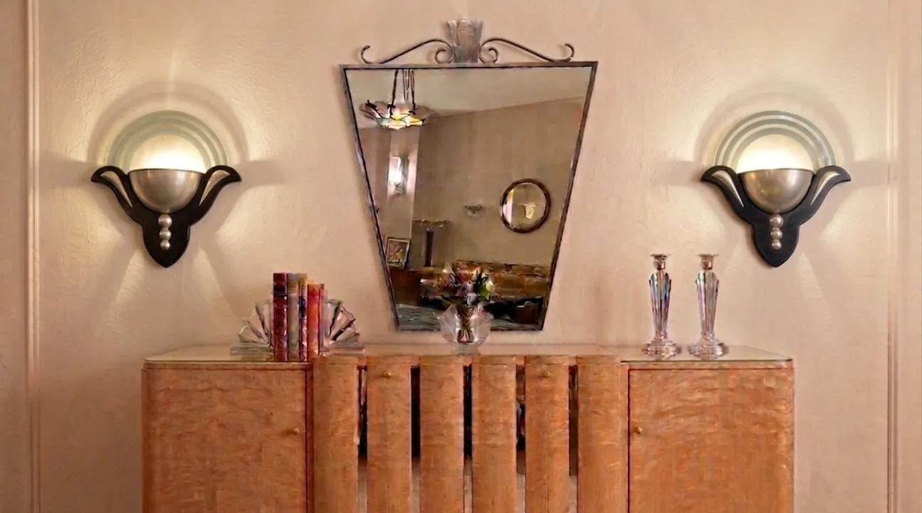 Pair of antique sconces in Art Deco style, with mirrors and elegant surroundings.