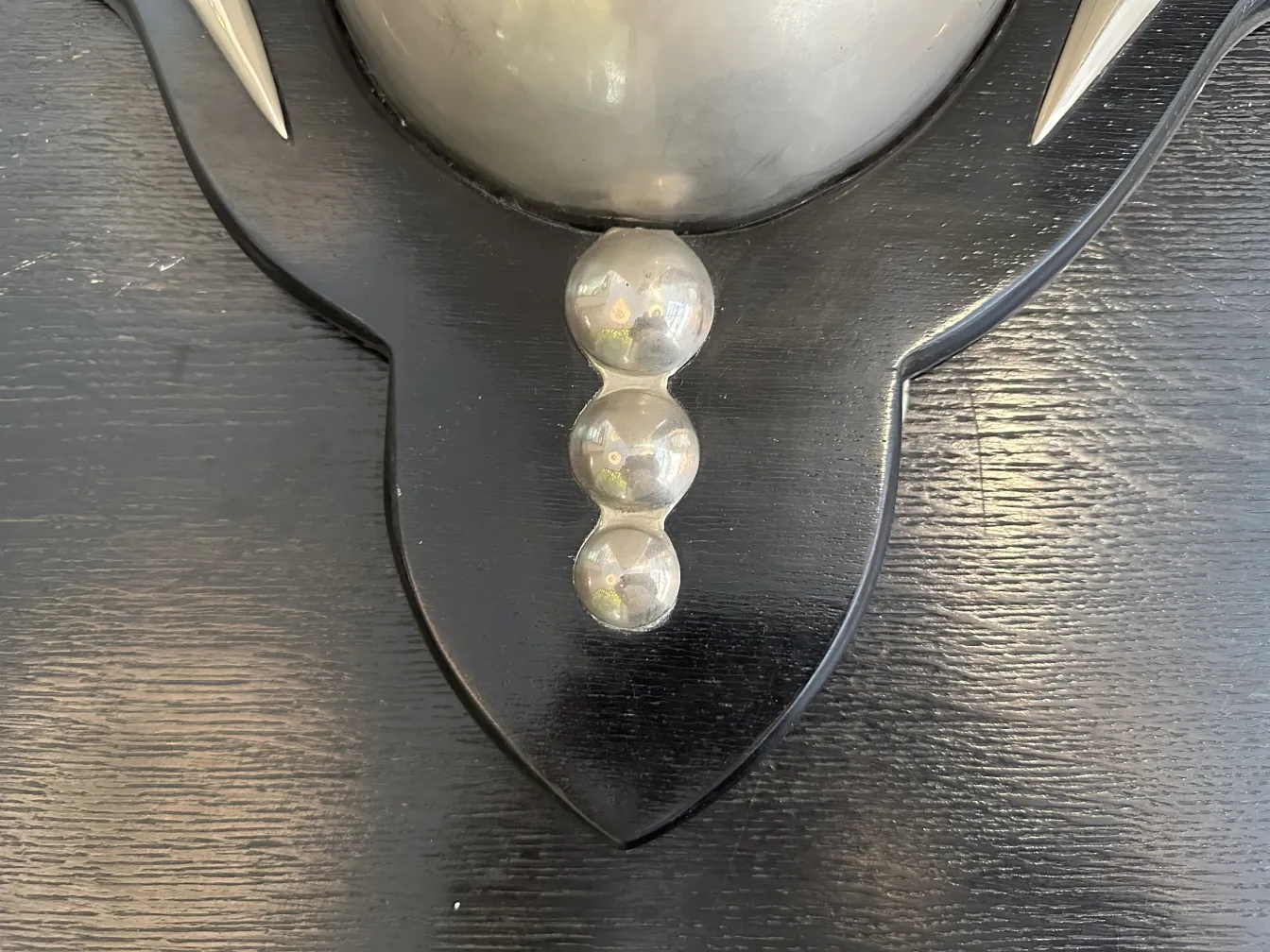 Pair of antique sconces featuring spherical details, styled against a dark wall