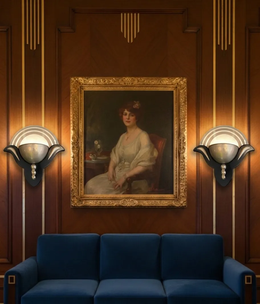 Pair of antique decorative sconces with elegant shape, illuminating a stylish room.