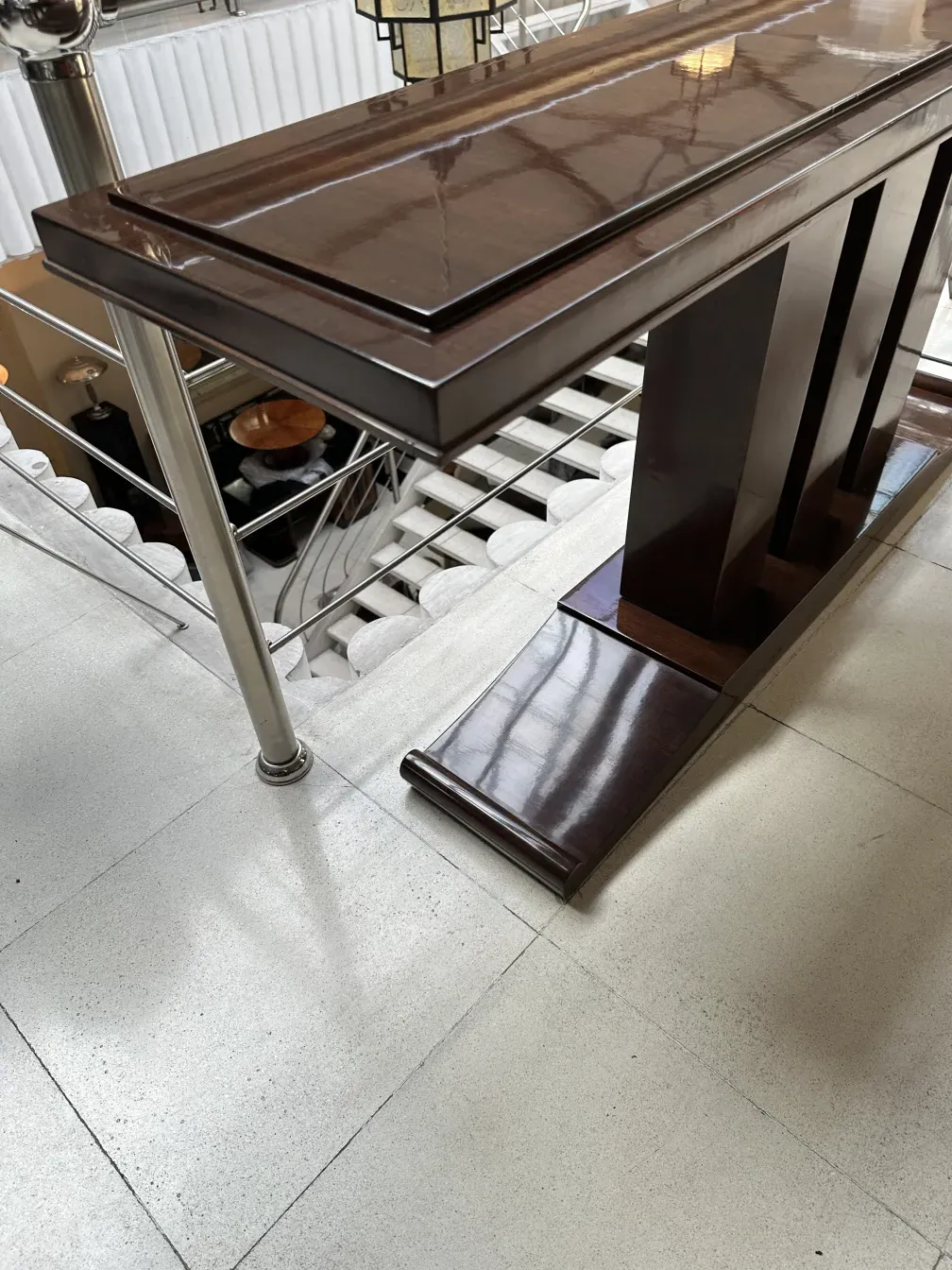 Side view of an antique elegant console in a decorative space.