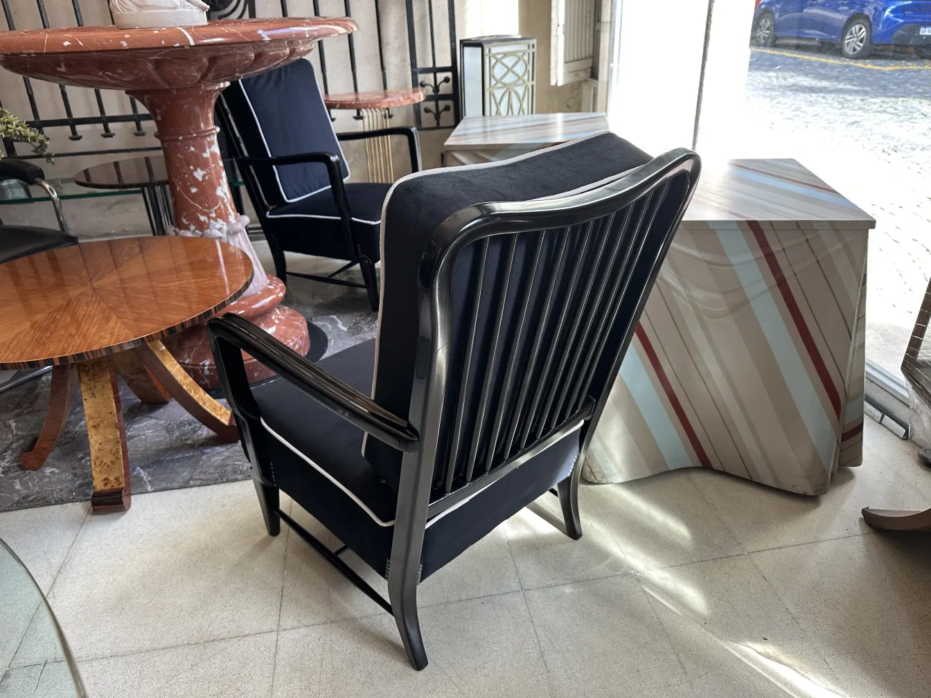 view of 2 antique armchairs in a cozy setting