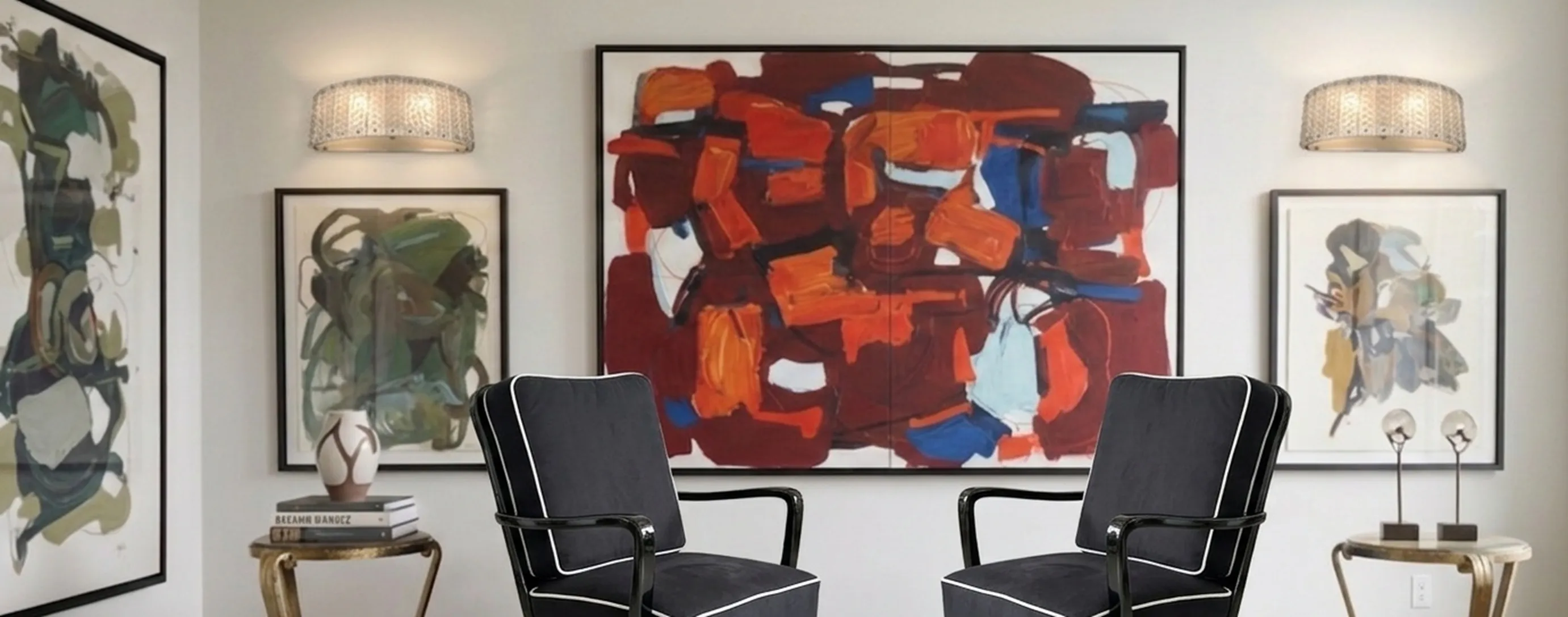two antique armchairs in a modern setting, decorated with contemporary art.