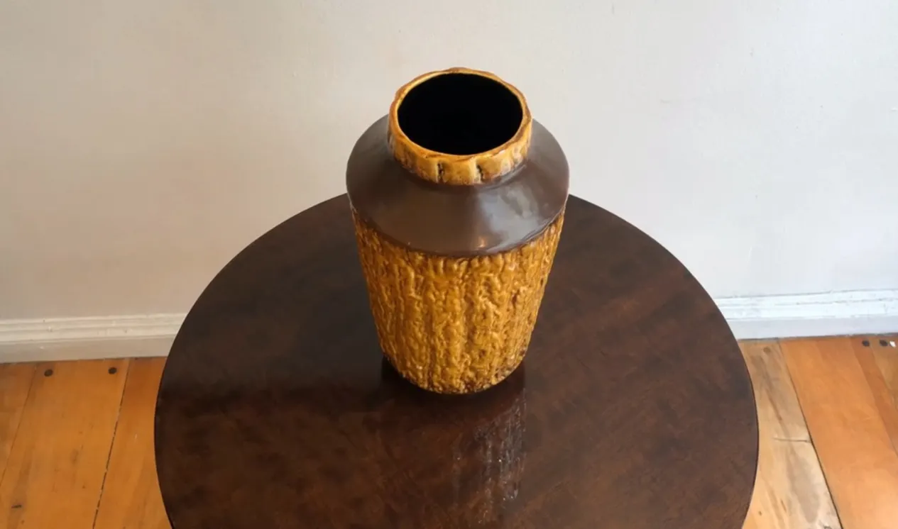 古老的陶瓷瓶，琥珀色，质地粗糙。