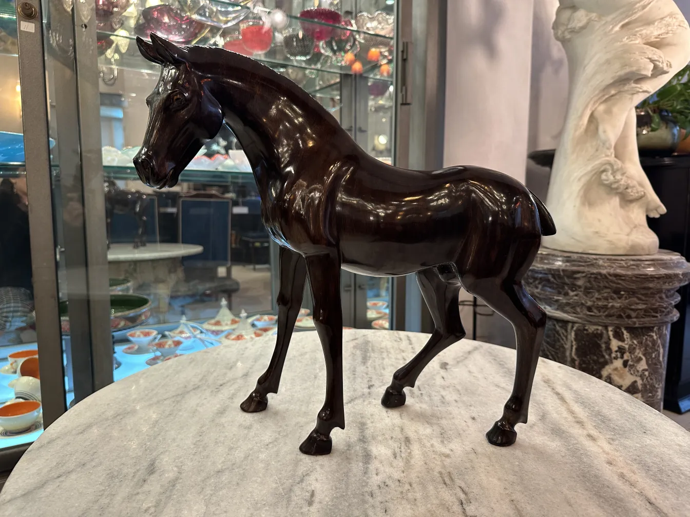 Scultura antica di un cavallo con superficie lucida.