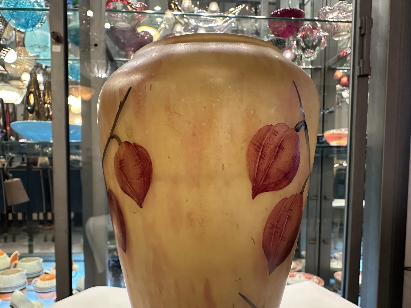 葉の装飾のあるロレインのサイン入り古代グラスの花瓶。古代のアートの一例。