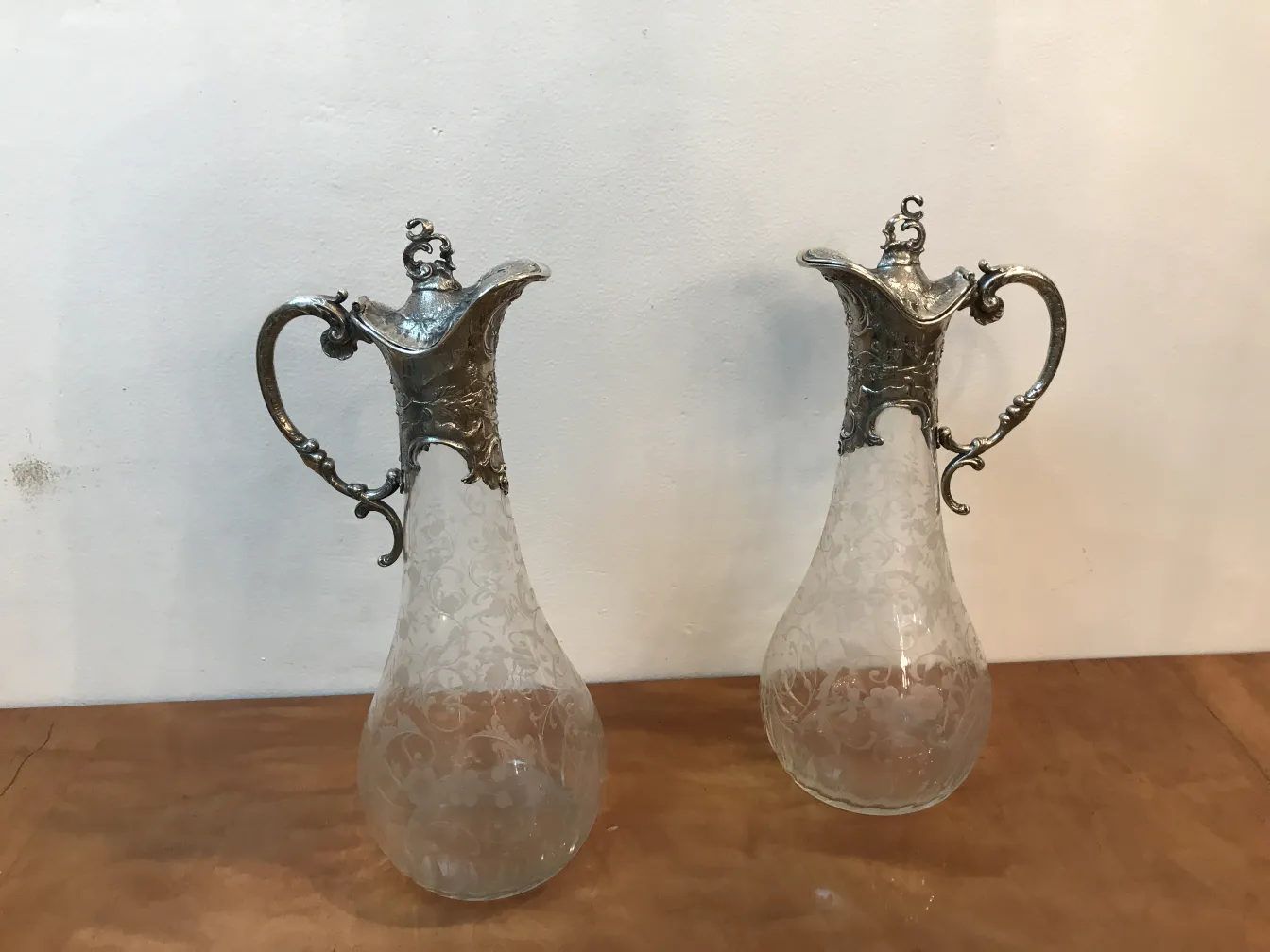 deux pichets antiques WMF avec un design complexe et des poignées décoratives, dans un cadre élégant