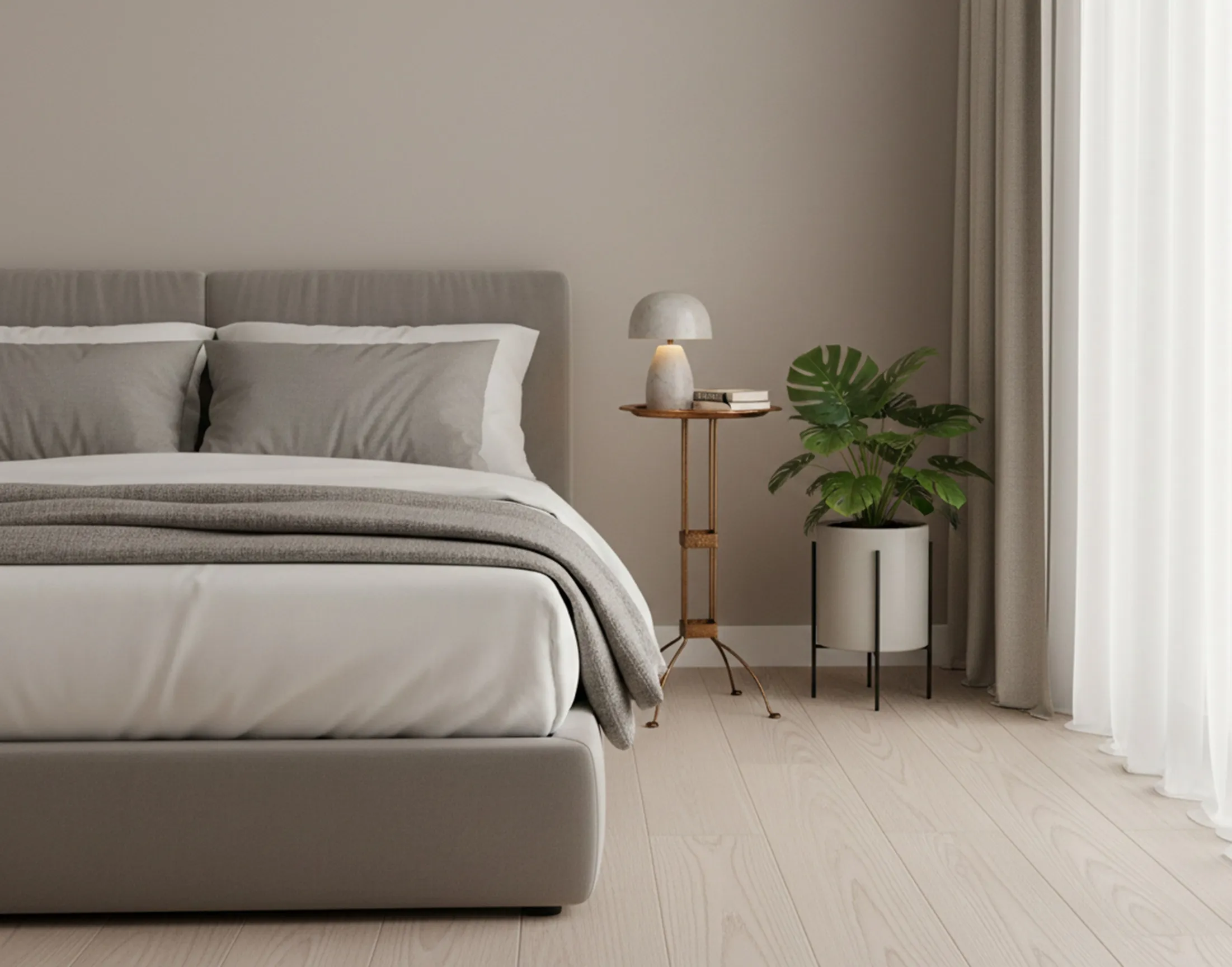 Antique table decorating a modern bedroom, with soft light and plants.