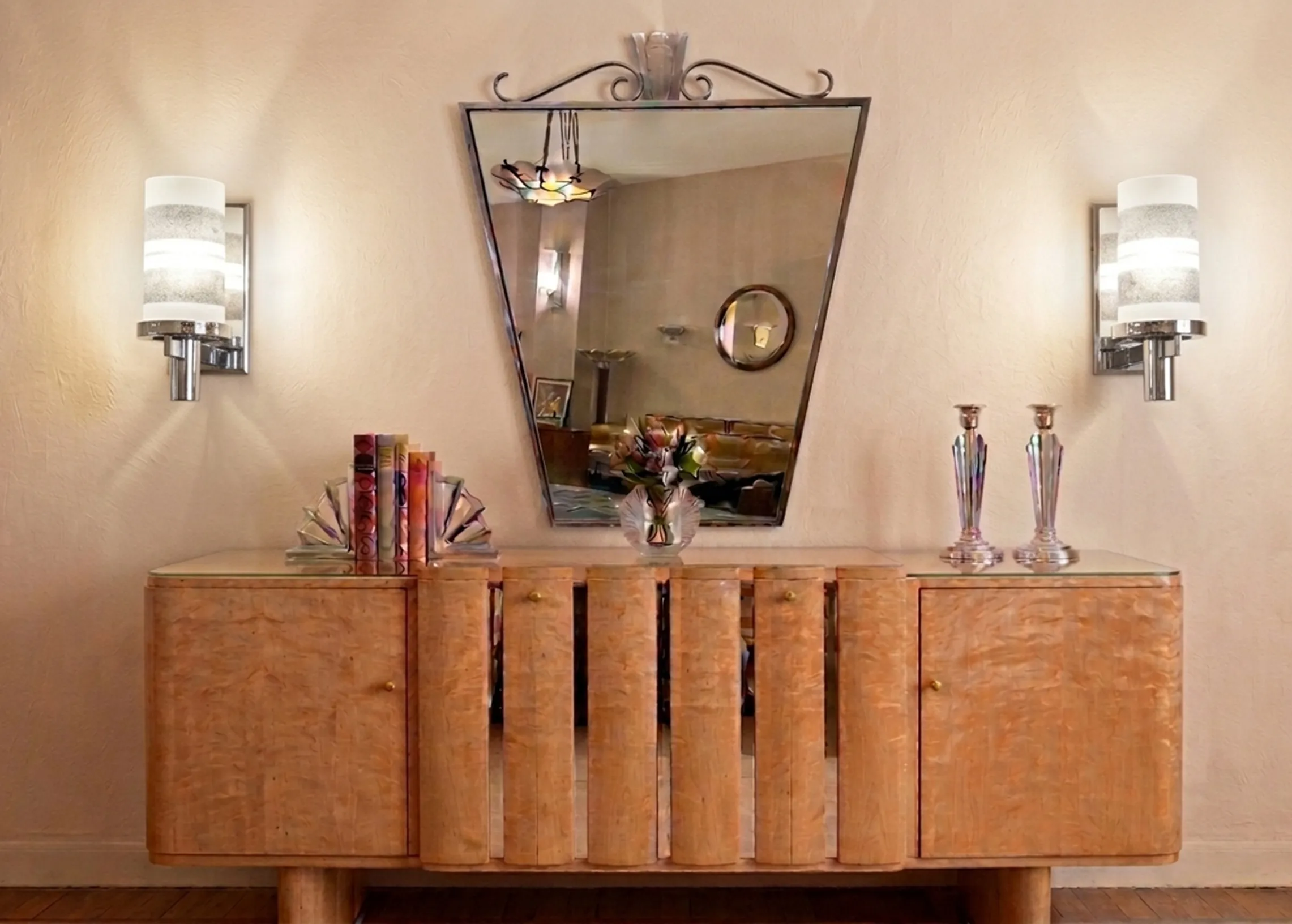 antique pair of sconces featuring elegant design on the wall, surrounded by a cozy atmosphere with a reflecting mirror