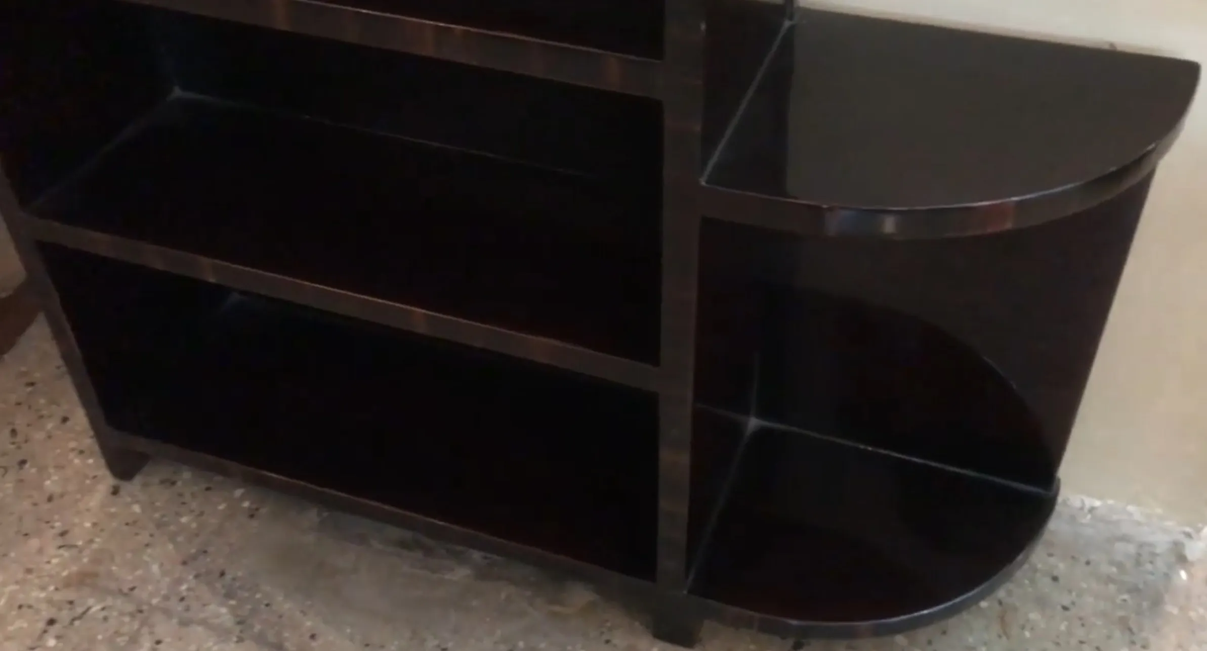 two antique bookcases with spacious shelves in neutral setting