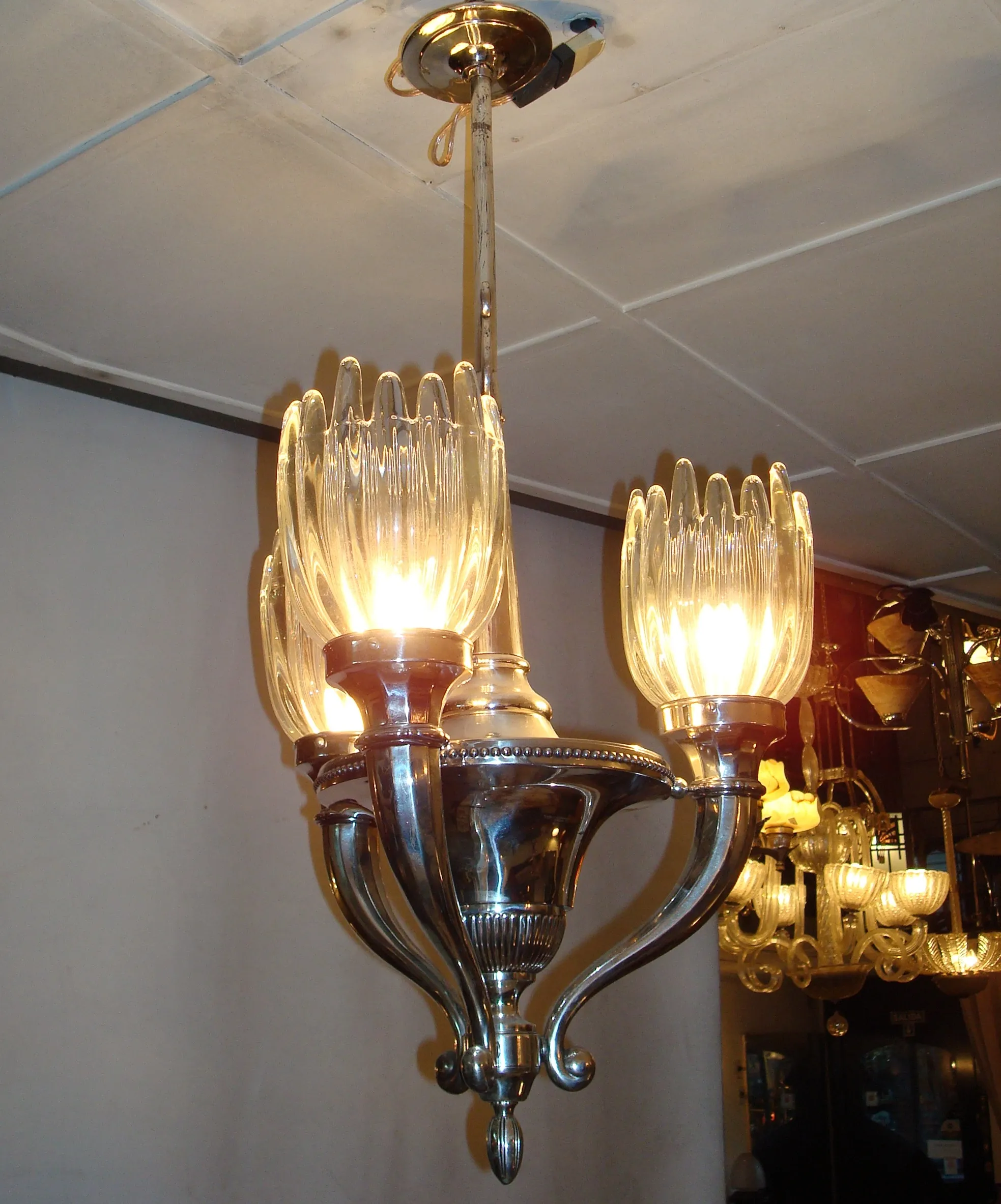 Antique hanging lamp with bright bulbs and elegant design, soft light background.