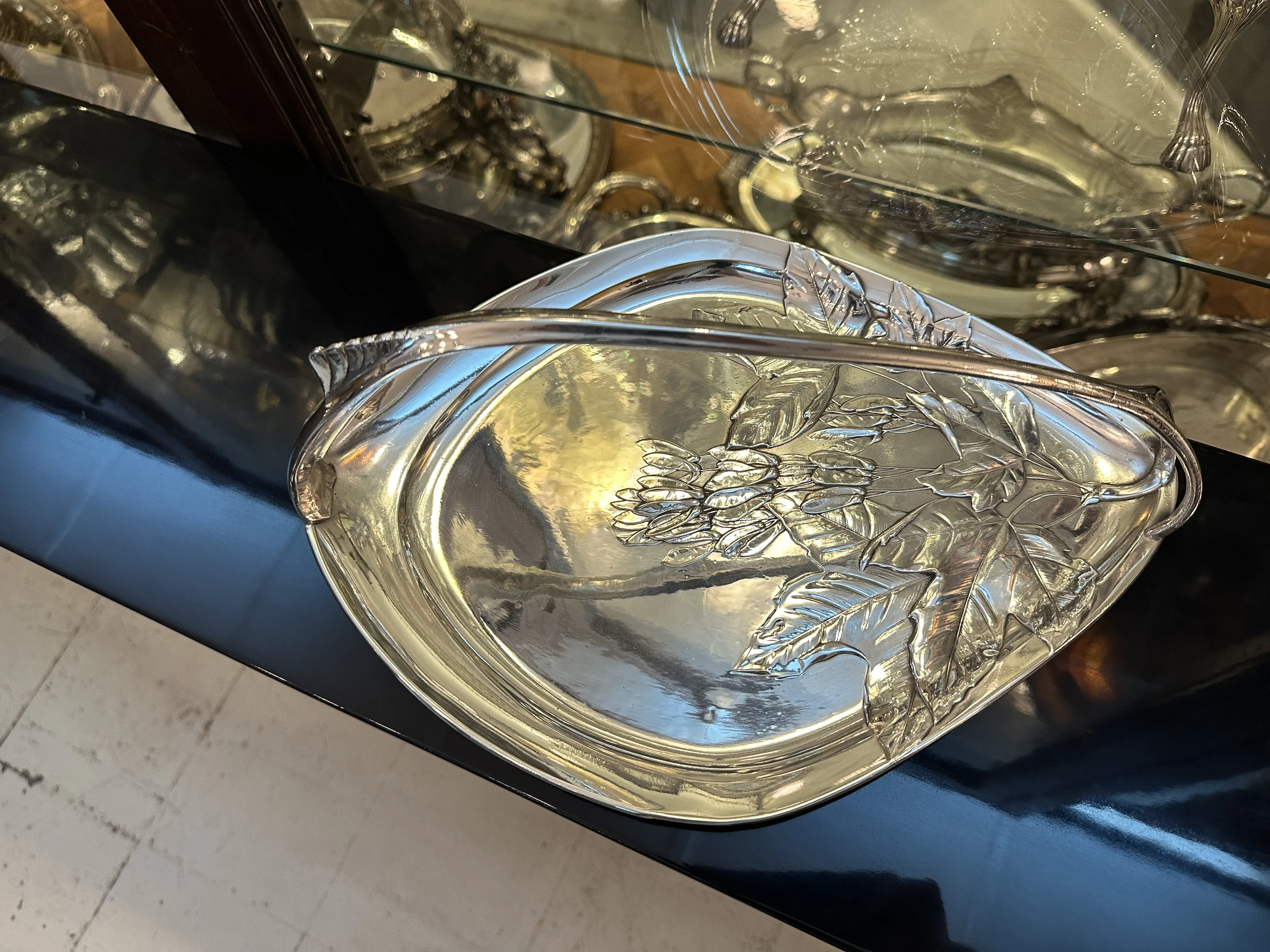 Antique tray with floral design and handle, perfect for cards.