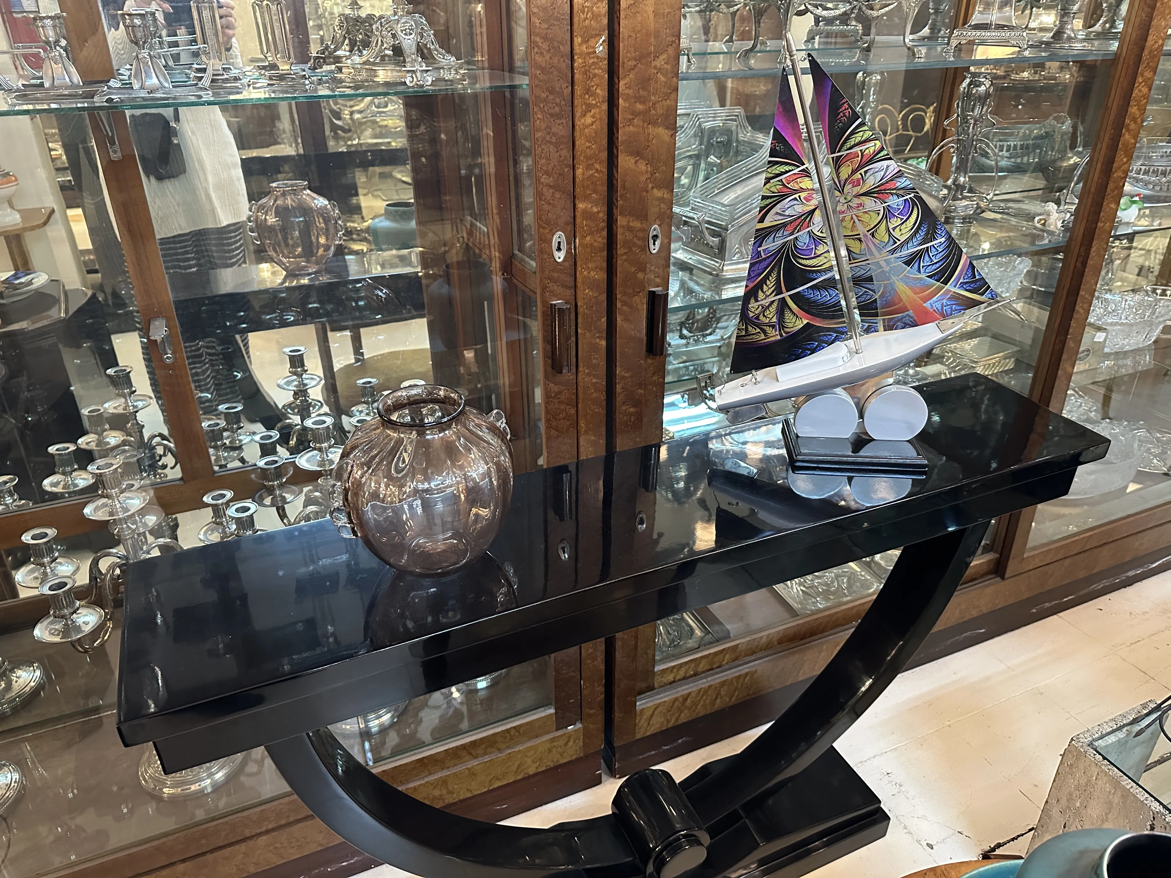 antique murano vase on shiny black table, subtle decor in background