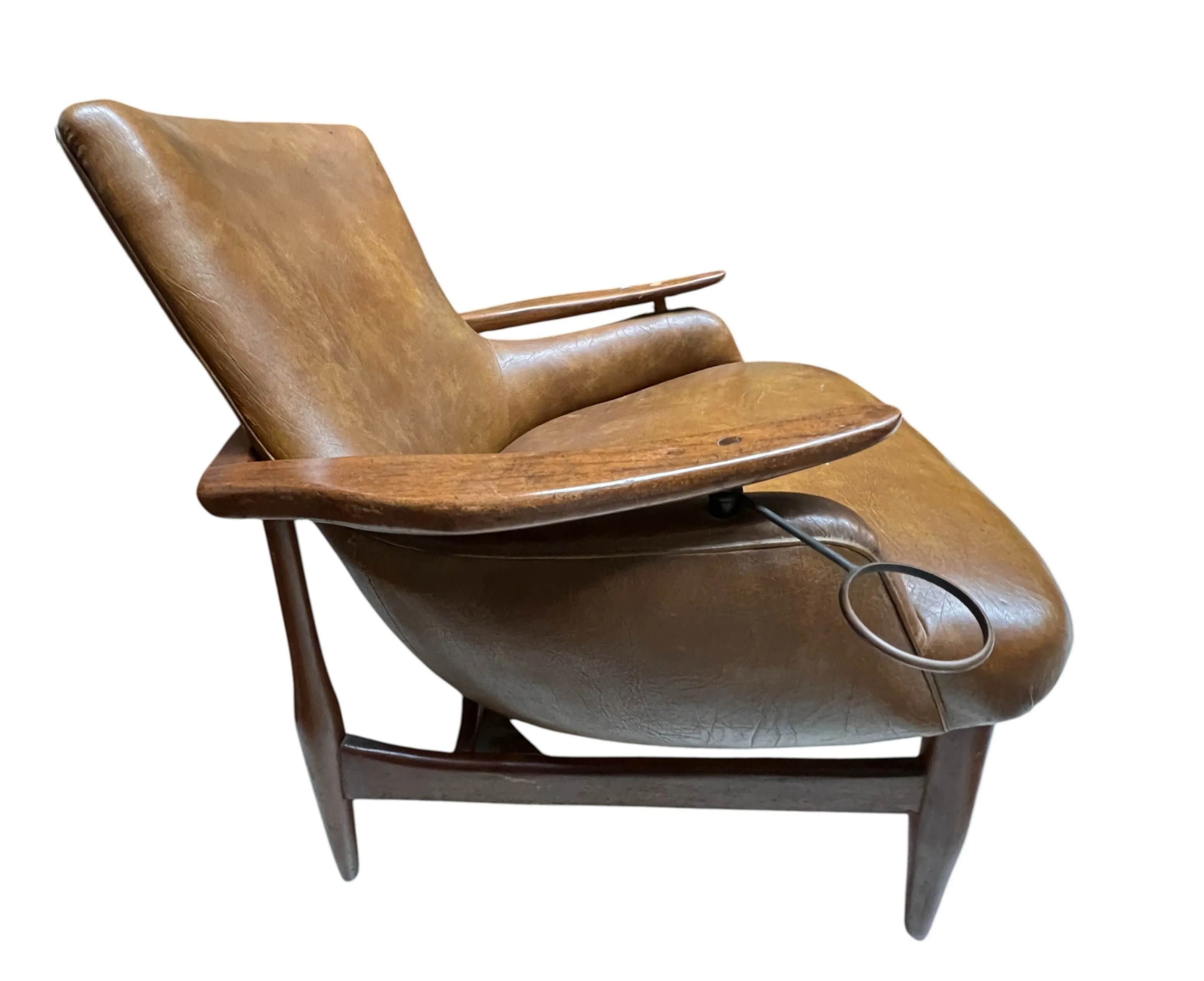 Two antique armchairs with a unique finn juhl design, set in a cozy environment.