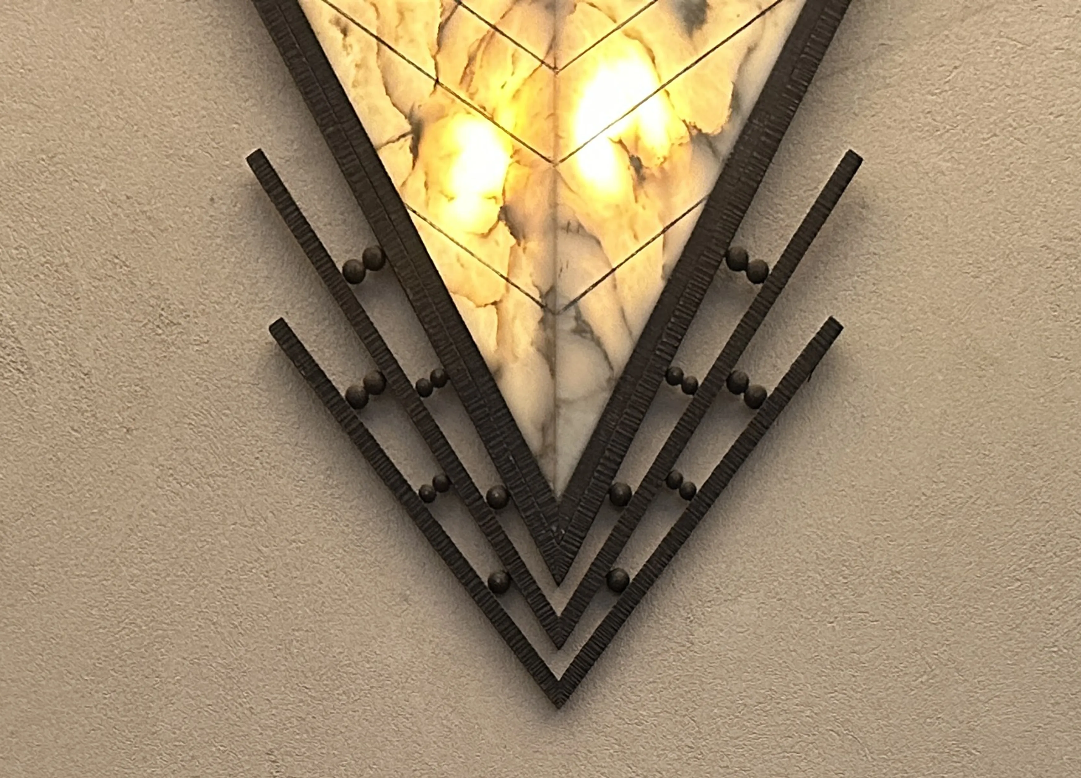 Antique sconces with decorative design on wall