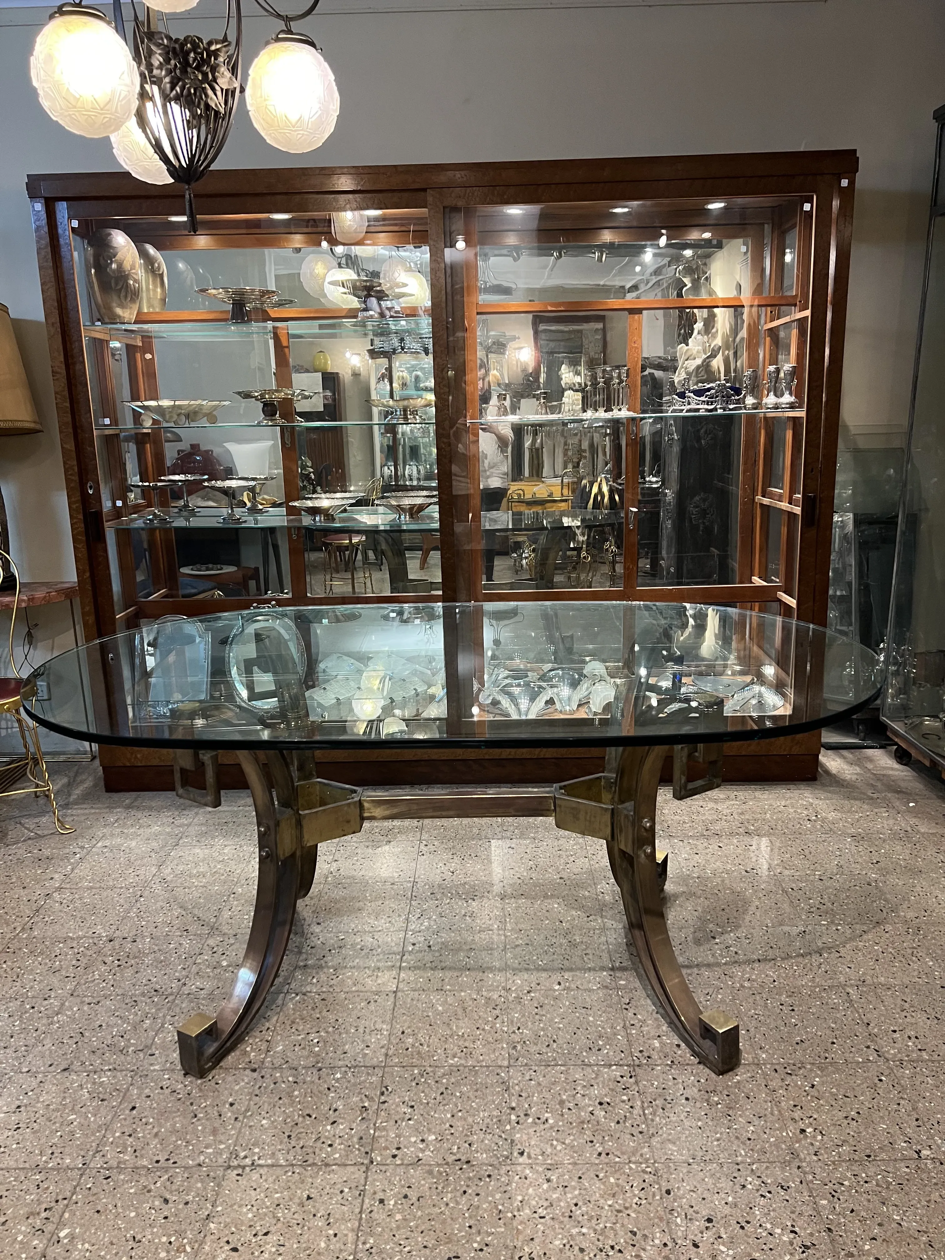Antique dining table with Art Deco design, seats 6, in an elegant setting.