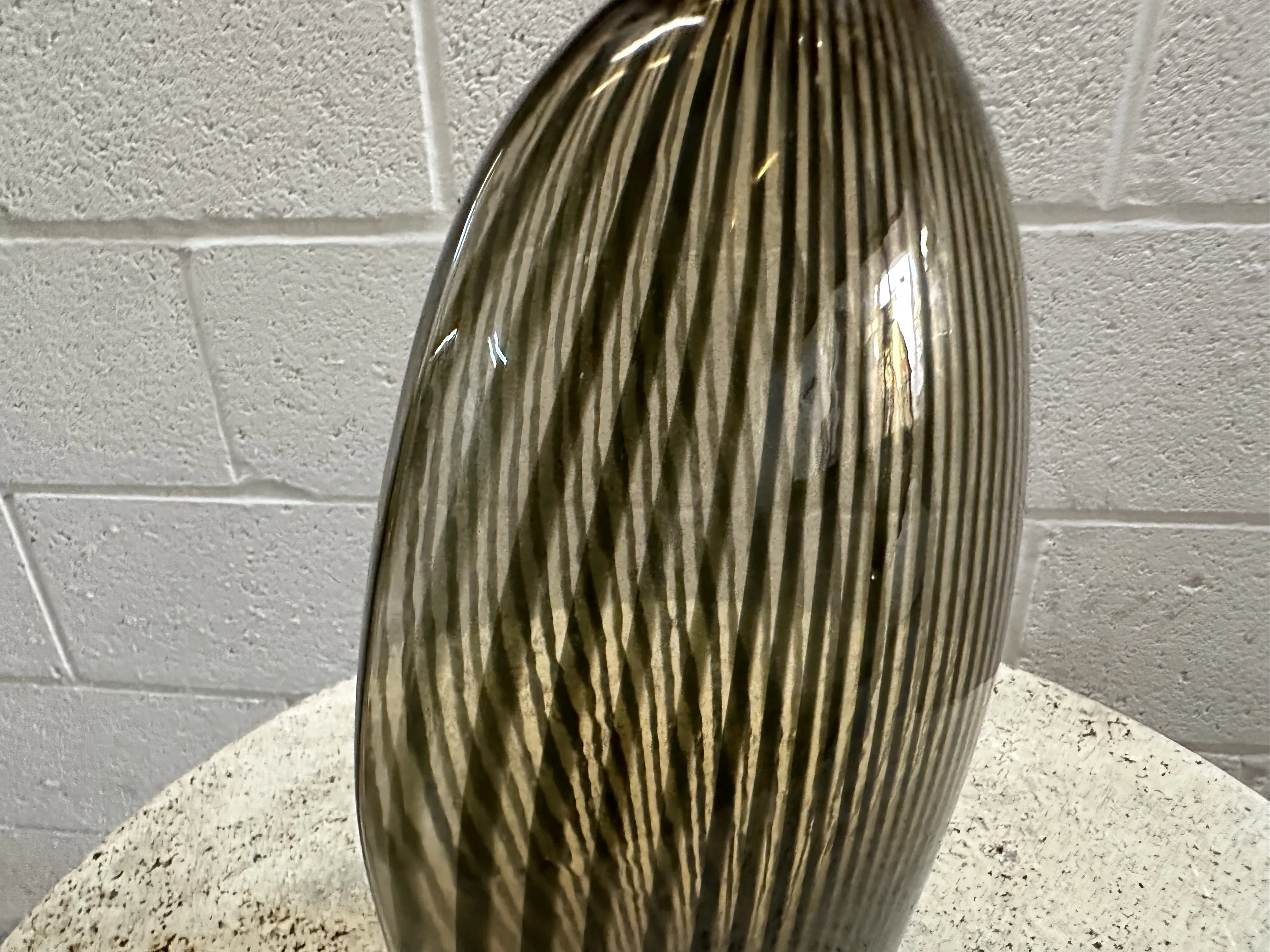 antique murano vase with stripes and sleek shape, set in context