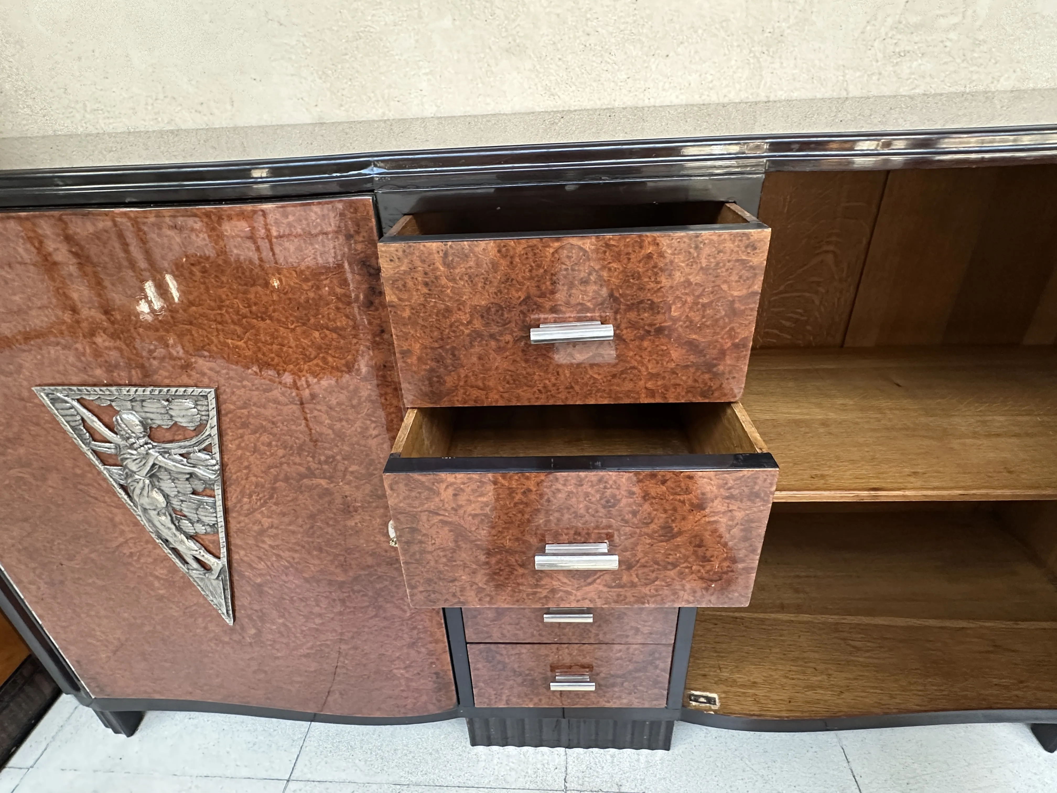 antique sideboard with decorative drawings and several drawers