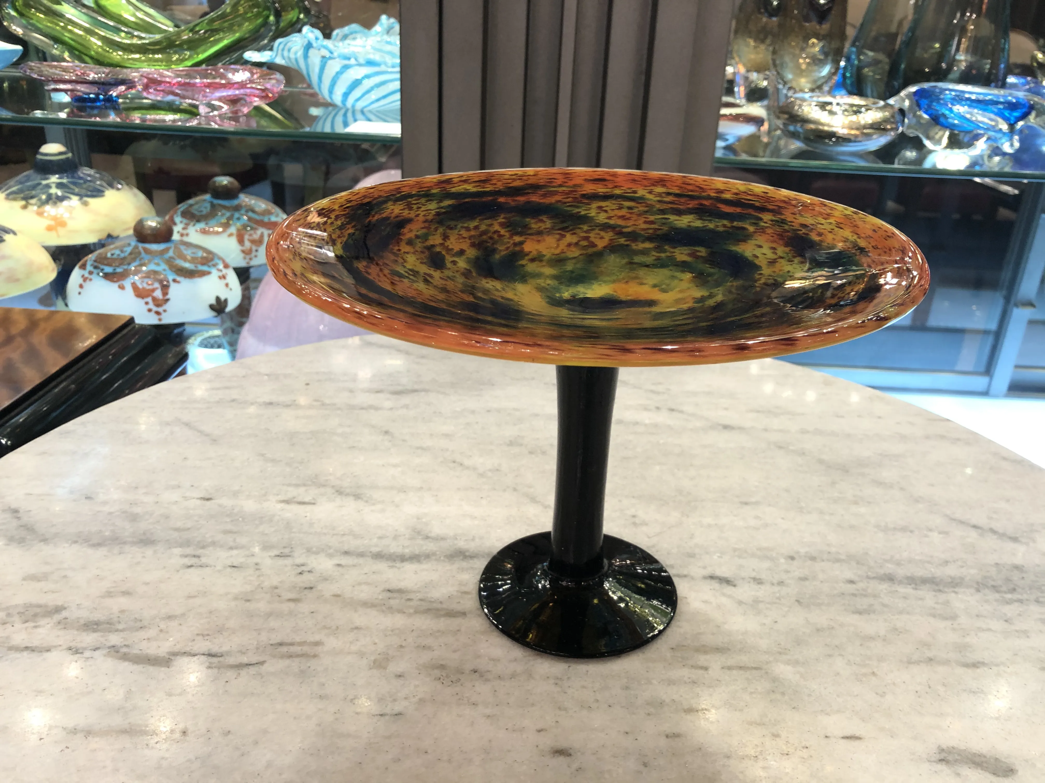 View of an antique signed glass by Schneider, decorated with vibrant colors.