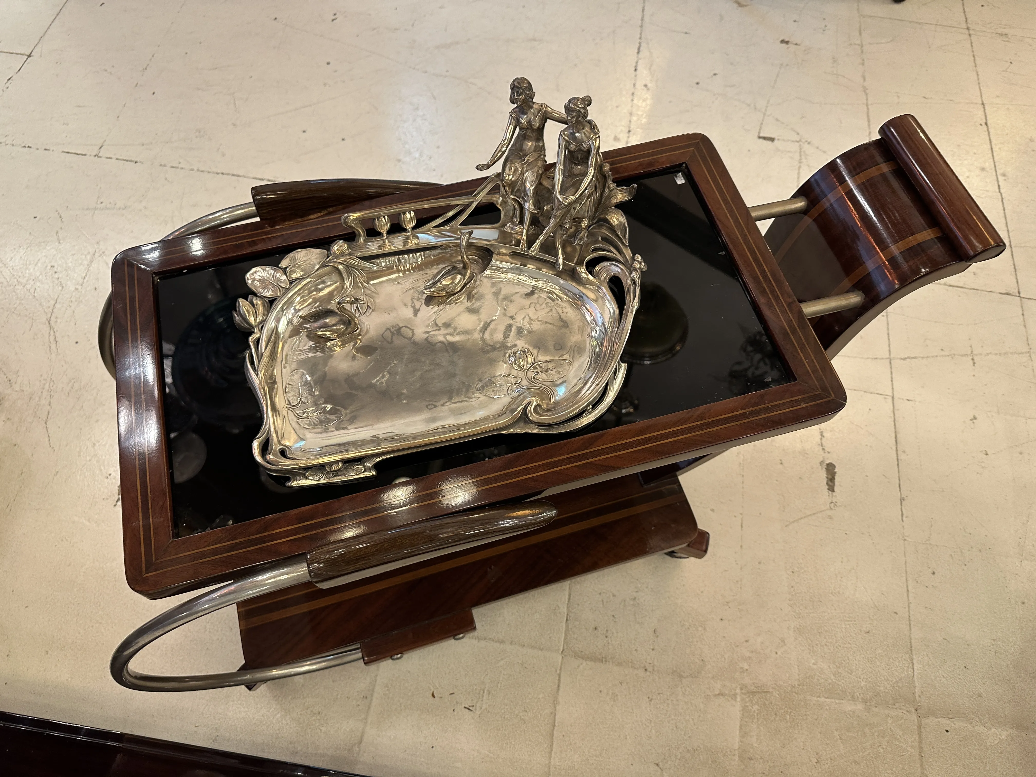 Elegant antique WMF card tray with decorative figure.