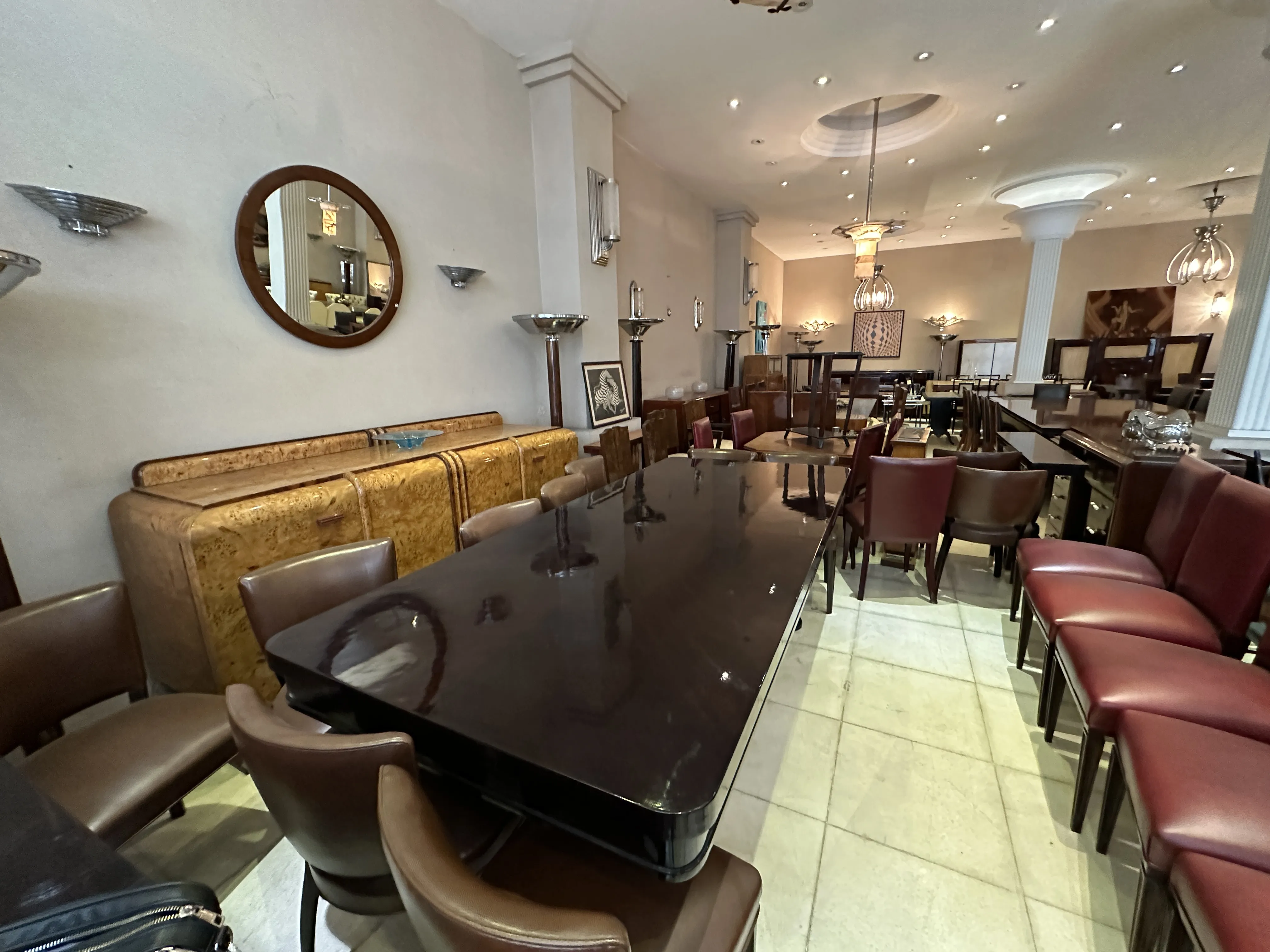 Antique Art Deco dining table for 10 people with surrounding chairs.